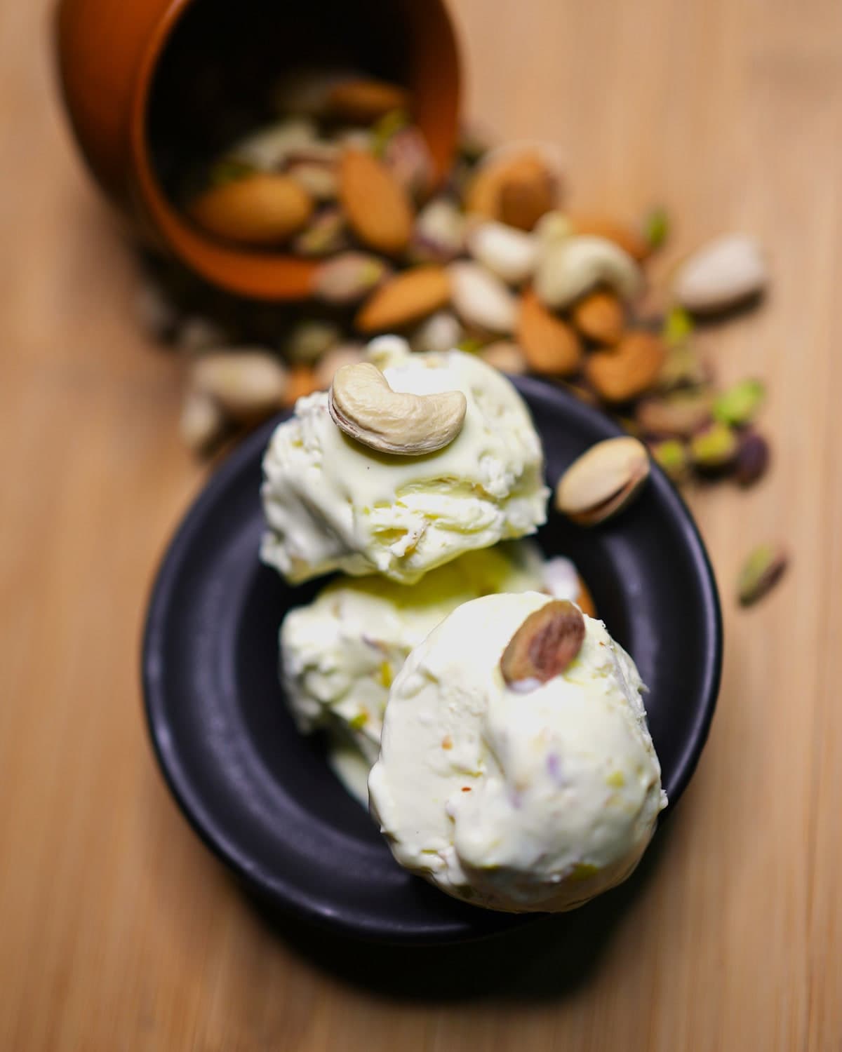 Kulfa ice cream topped with nuts