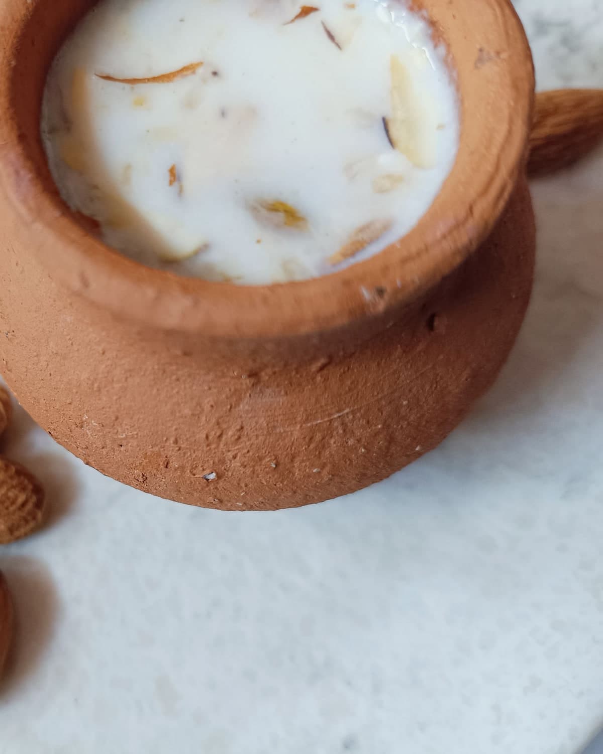 Rabri doodh in a clay pot with almonds