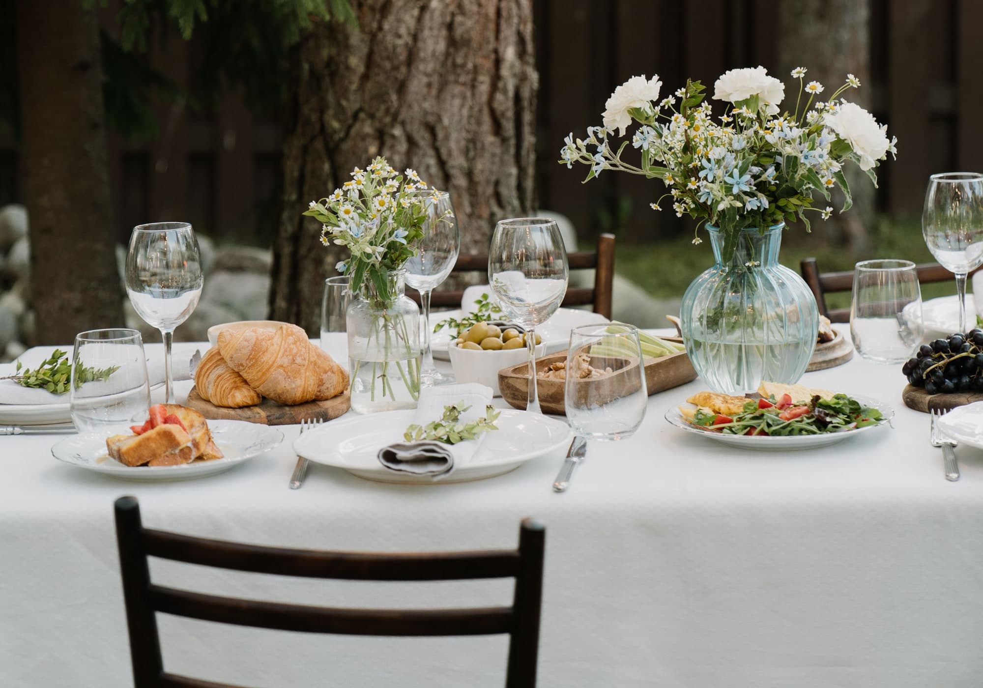 An outdoor table laid with flowers