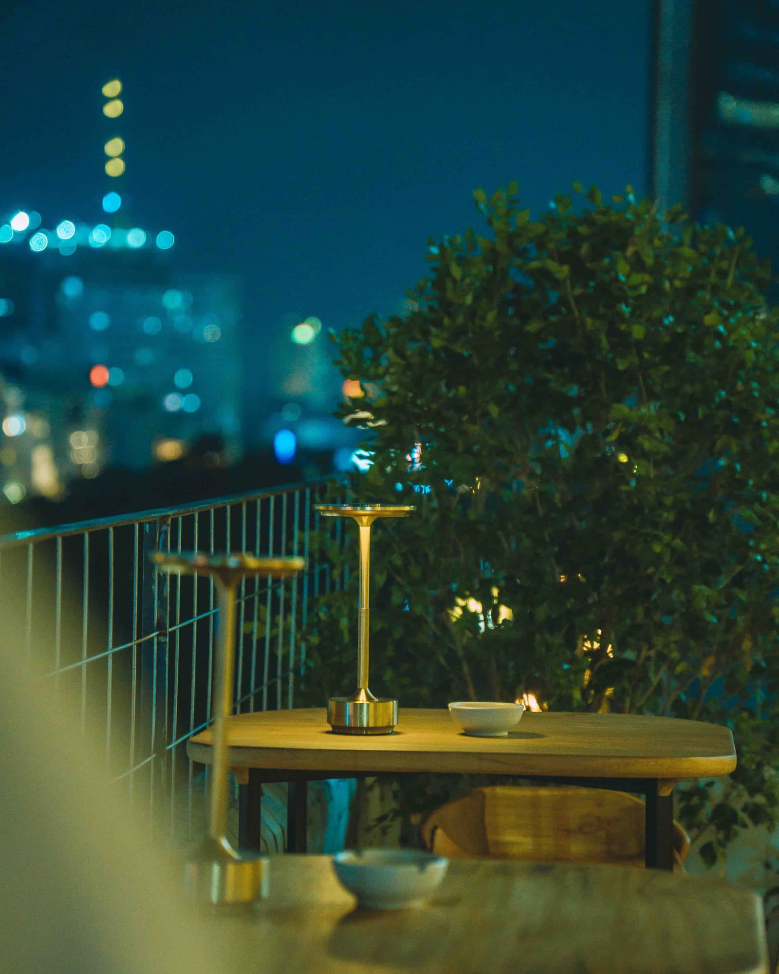 A table lamp glowing on the rooftop at dusk