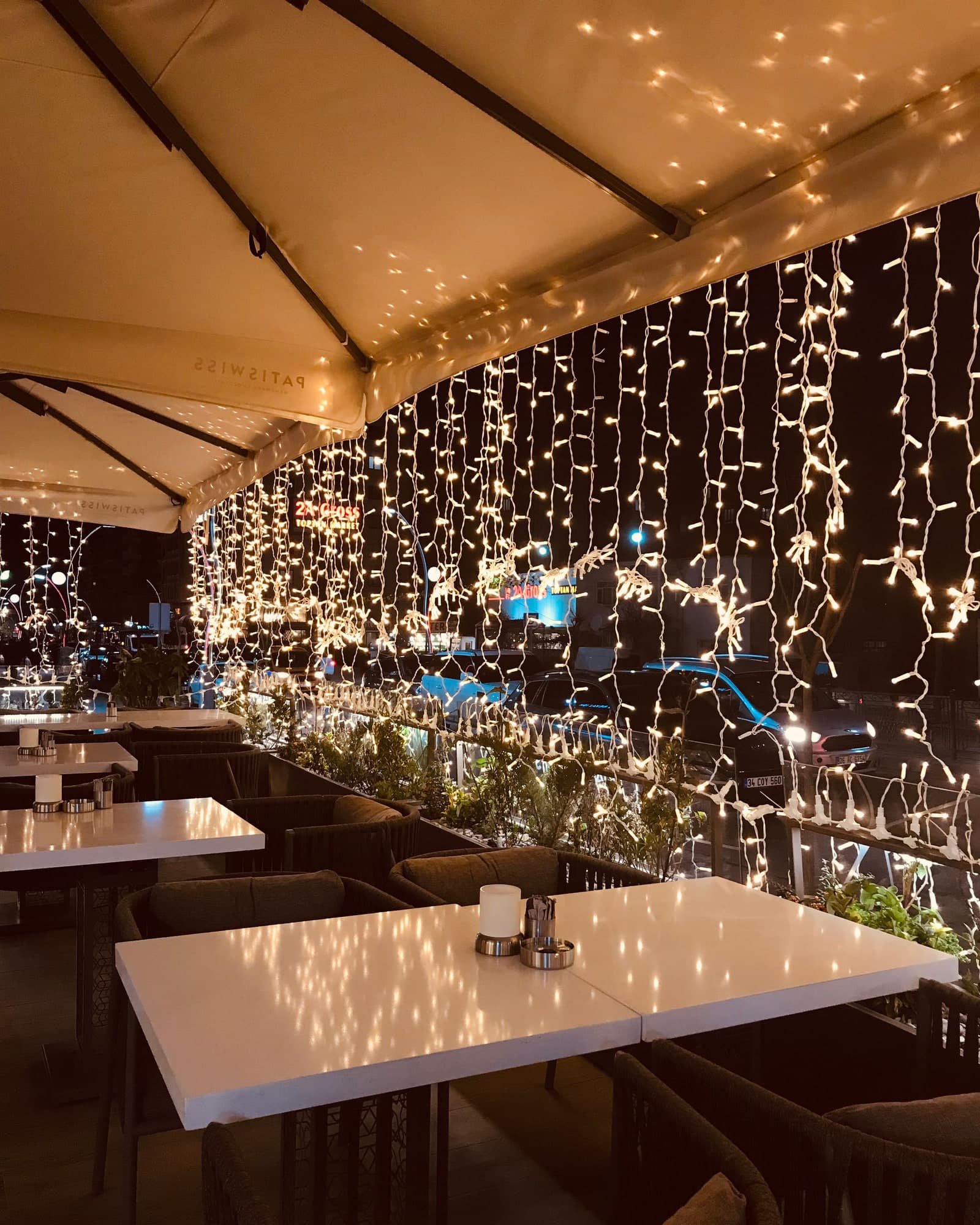 Terrace tables under curtain lights