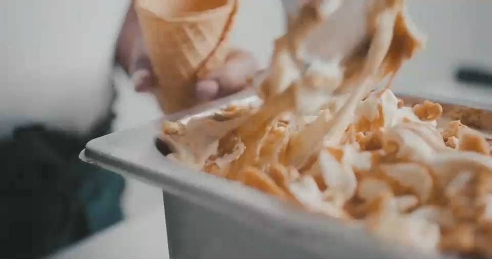Ice cream being scooped from a tray